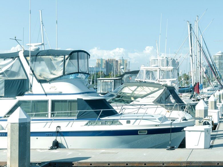 white and blue boats on dock during daytime